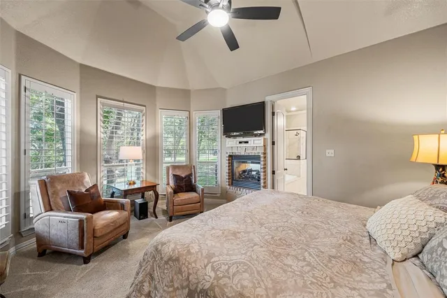 a living room with furniture a flat screen tv and a large window