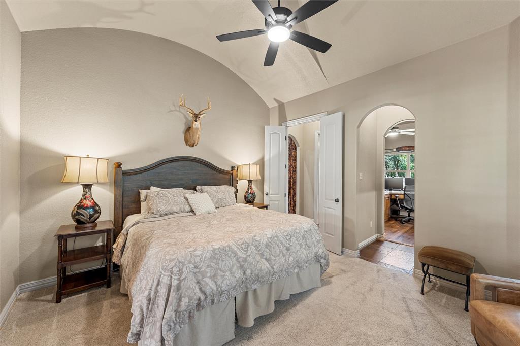 338 Estes Rch Road Bruceville, TX 76630 - Photo 19 of 40 a bedroom with a bed and a chandelier