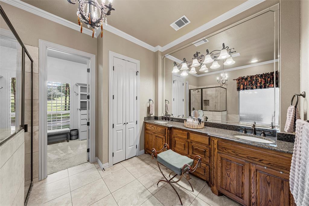338 Estes Rch Road Bruceville, TX 76630 - Photo 20 of 40 a spacious bathroom with a granite countertop sink a mirror and a shower