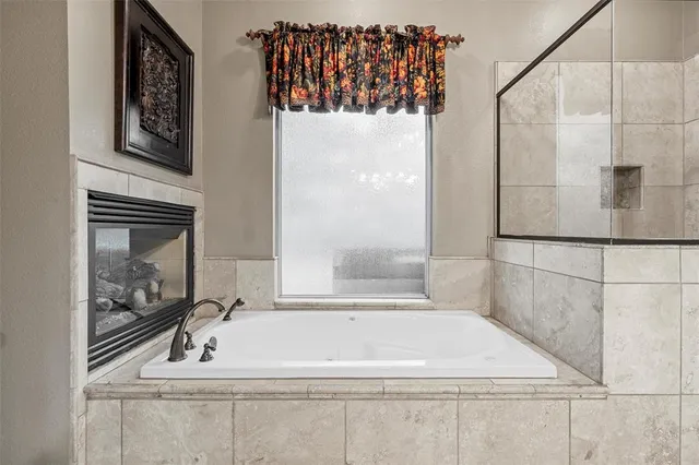 a bathroom with a bathtub and shower