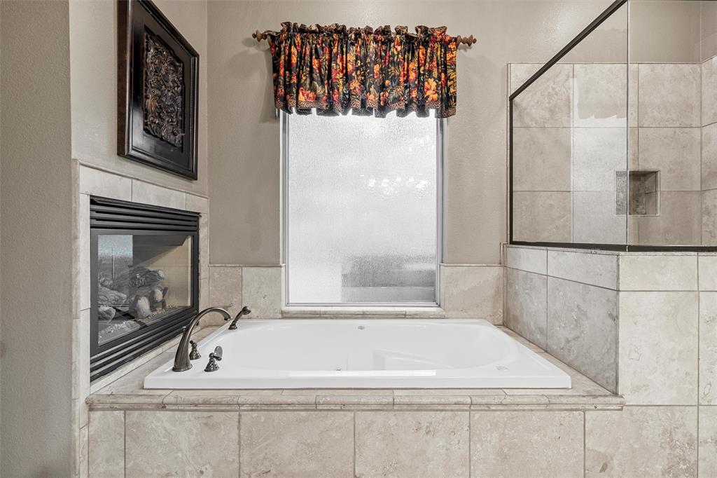 338 Estes Rch Road Bruceville, TX 76630 - Photo 21 of 40 a bathroom with a bathtub and shower