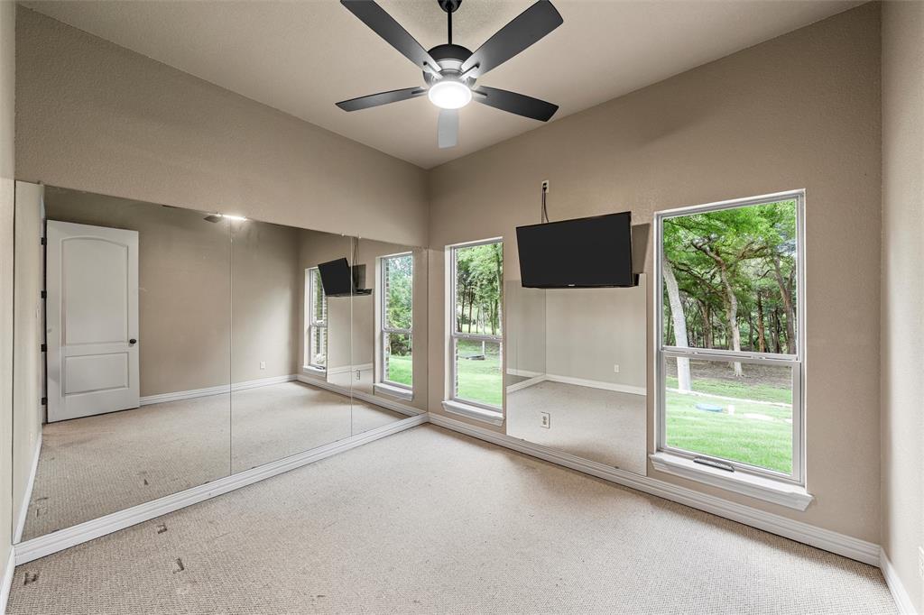 338 Estes Rch Road Bruceville, TX 76630 - Photo 23 of 40 a view of an empty room with a window and a ceiling fan