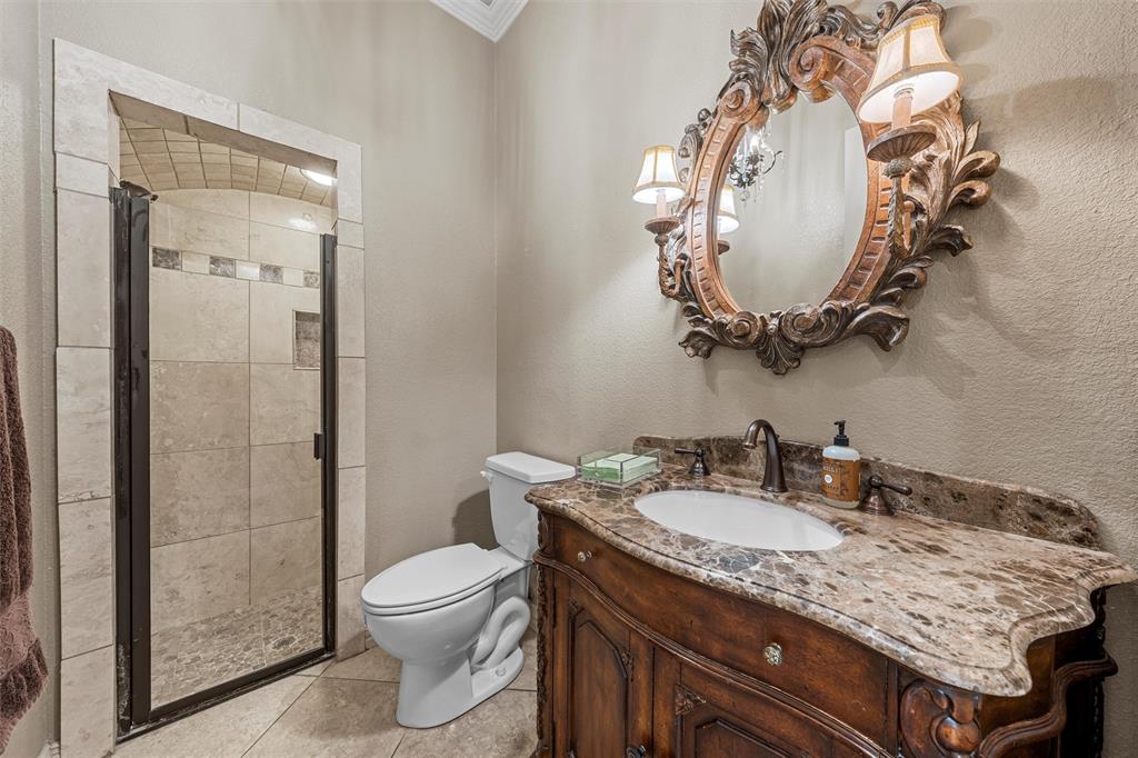 338 Estes Rch Road Bruceville, TX 76630 - Photo 25 of 40 a bathroom with a granite countertop toilet sink and mirror