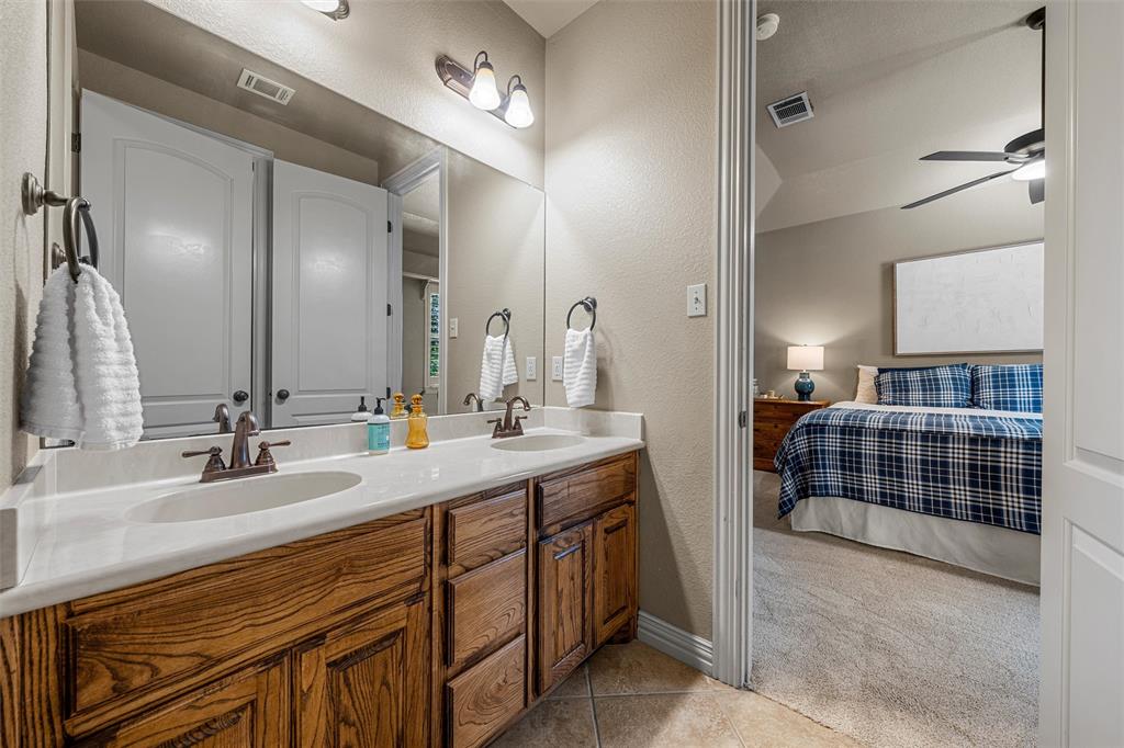 338 Estes Rch Road Bruceville, TX 76630 - Photo 30 of 40 a en suite bathroom with double vanity and a mirror