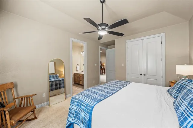 a bedroom with a large bed and a chandelier