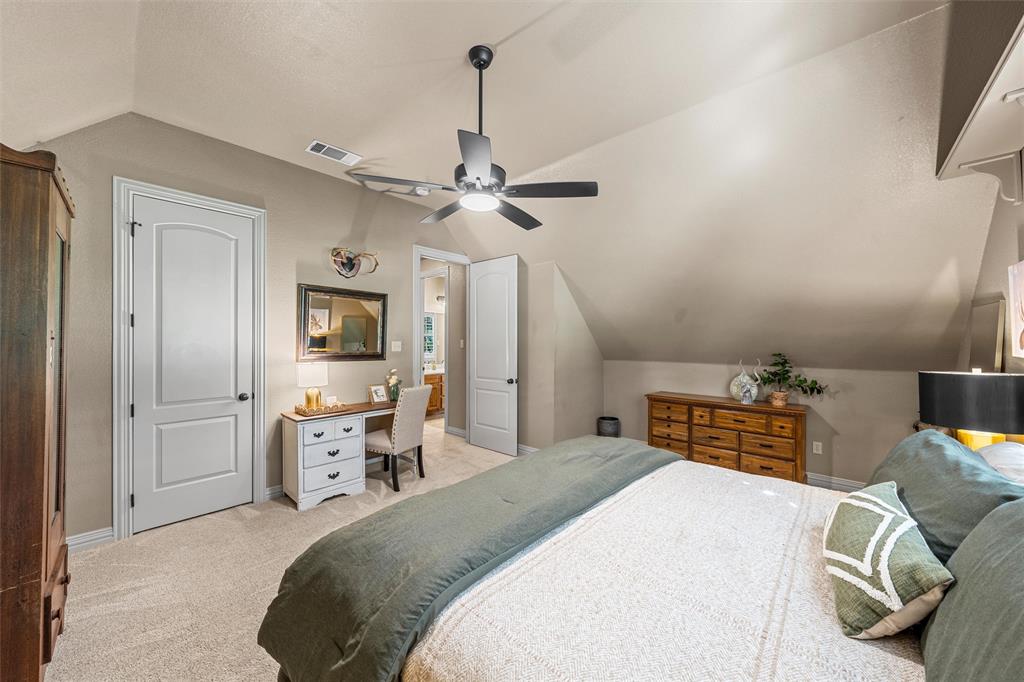 338 Estes Rch Road Bruceville, TX 76630 - Photo 34 of 40 a bedroom with a bed and a chandelier