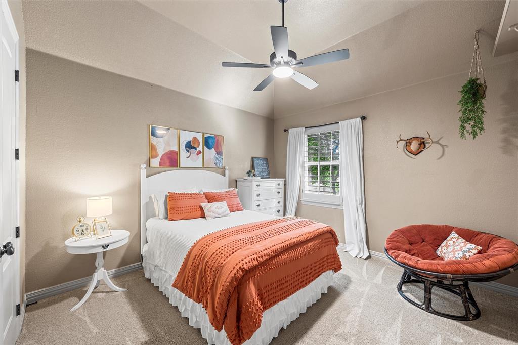 338 Estes Rch Road Bruceville, TX 76630 - Photo 35 of 40 a bedroom with a bed a dresser and chair