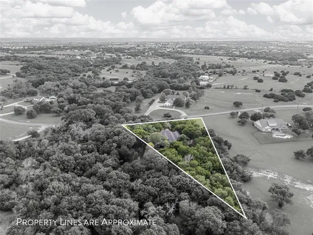 a picture of a kitchen with refrigerator and mirror
