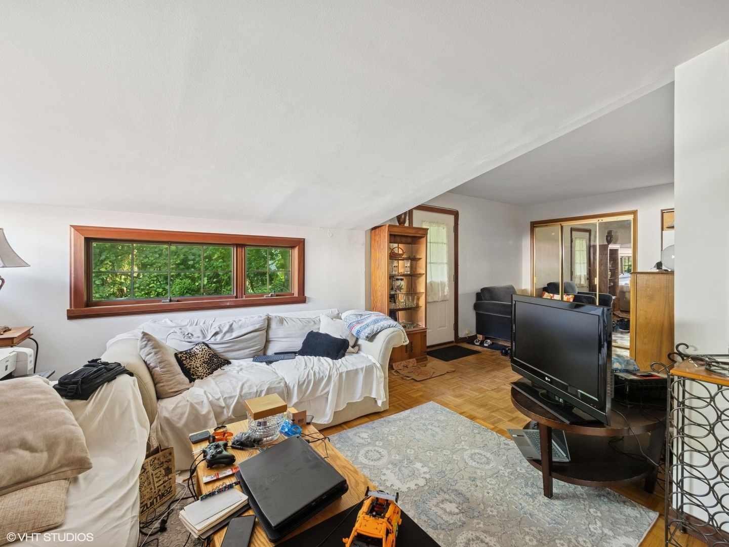 724 South Plum Grove Road Palatine, IL 60067 - Photo 15 of 37 a living room with furniture floor to ceiling window and a flat screen tv