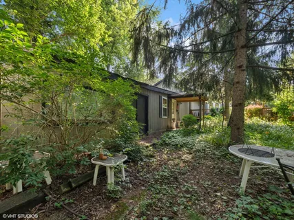 a view of house with backyard