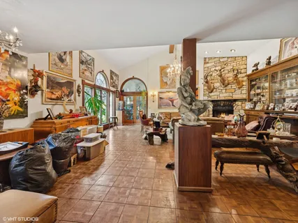a living room with lots of furniture and a chandelier