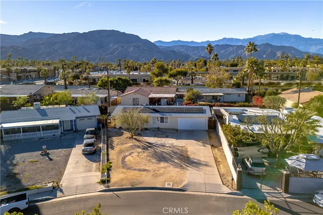 a view of balcony with two chairs and a potted plant