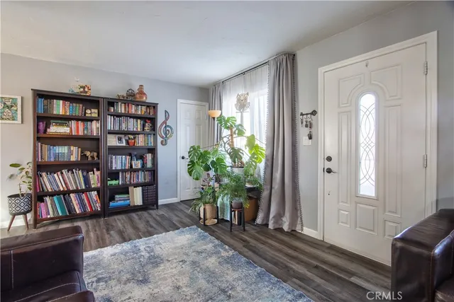 a living room with furniture and a book shelf