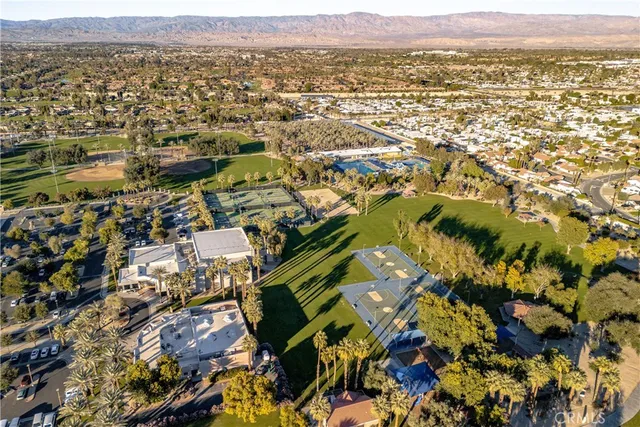 an aerial view of residential houses with outdoor space and swimming pool
