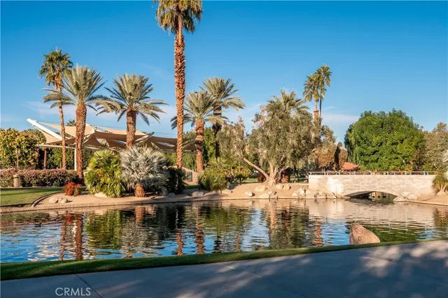 a view of swimming pool with outdoor seating and trees