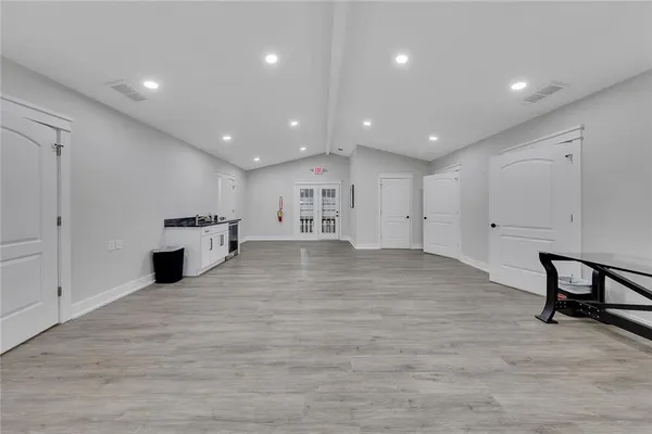 a view of a kitchen with furniture and wooden floor