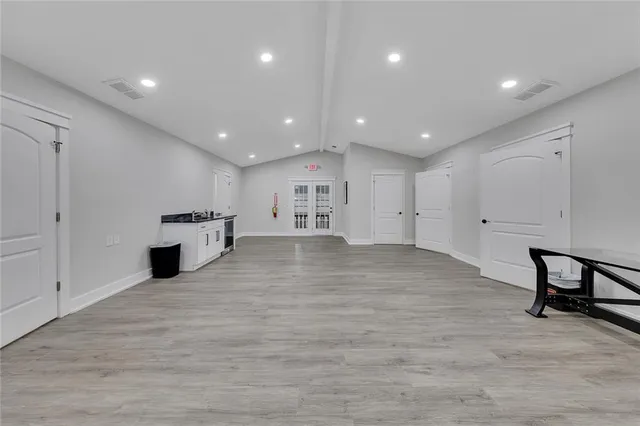 a view of a kitchen with furniture and wooden floor