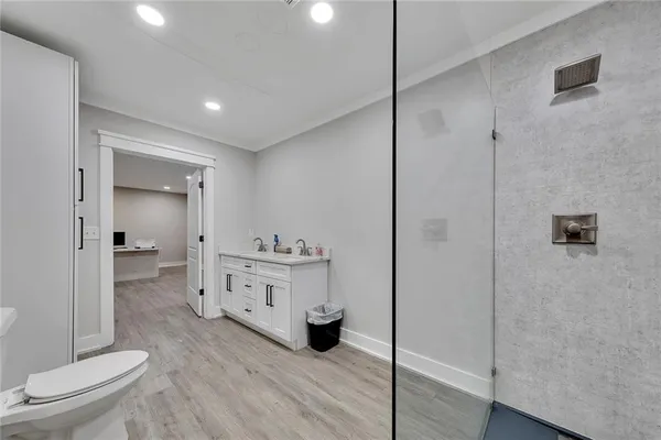 a bathroom with a sink a toilet and shower