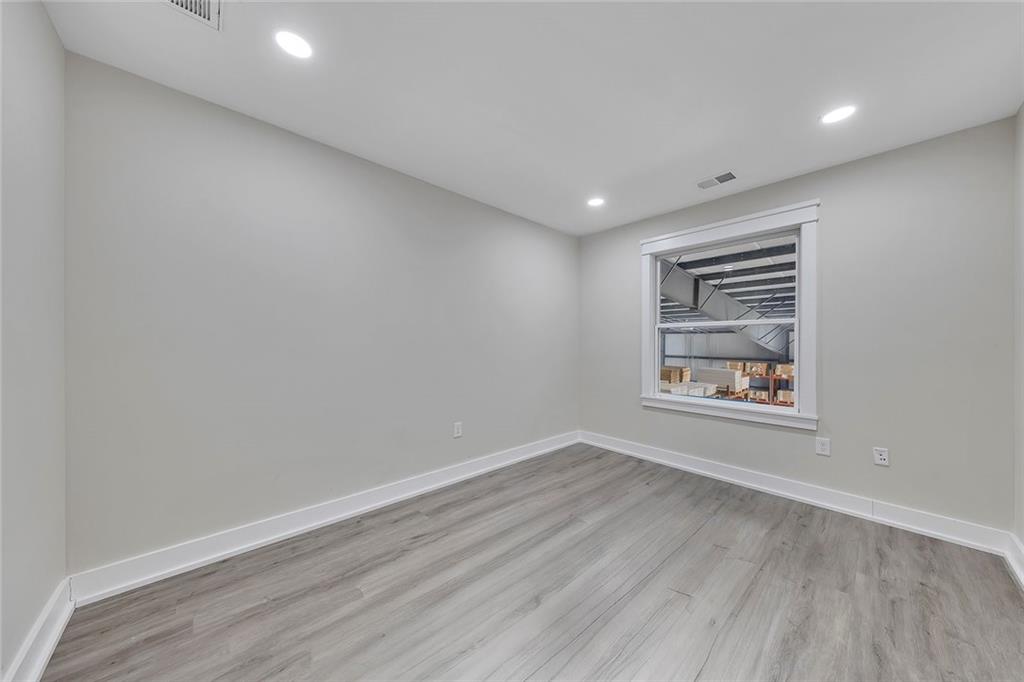 84 Lower Dowda Mill Road Jasper, GA 30143 - Photo 20 of 29 a view of an empty room with a window and wooden floor