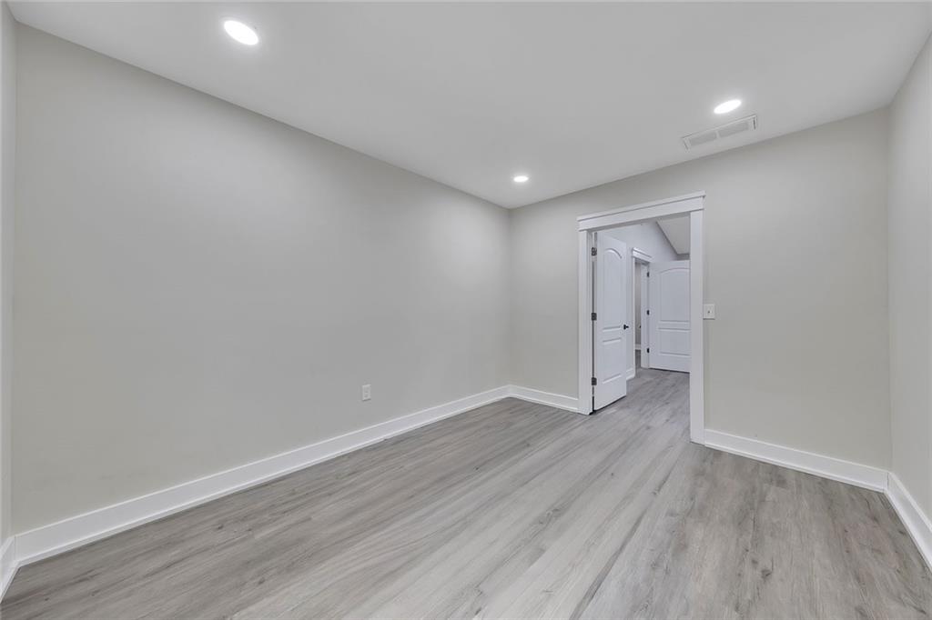 84 Lower Dowda Mill Road Jasper, GA 30143 - Photo 21 of 29 a view of an empty room with wooden floor