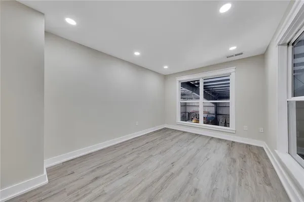 a view of wooden floor and windows in a room