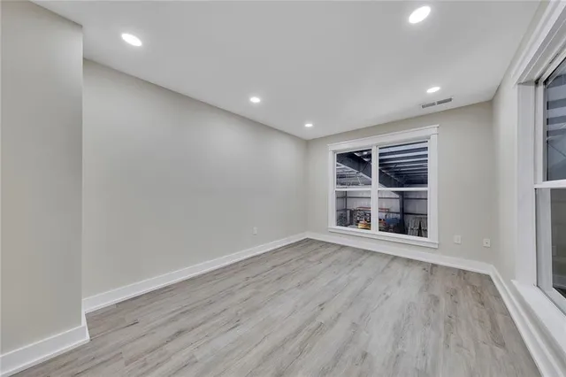 a view of wooden floor and windows in a room