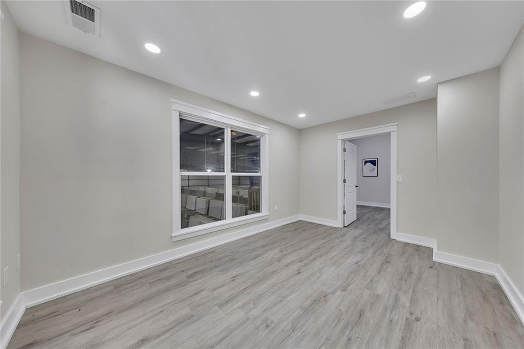 84 Lower Dowda Mill Road Jasper, GA 30143 - Photo 26 of 29 a view of empty room with wooden floor and windows