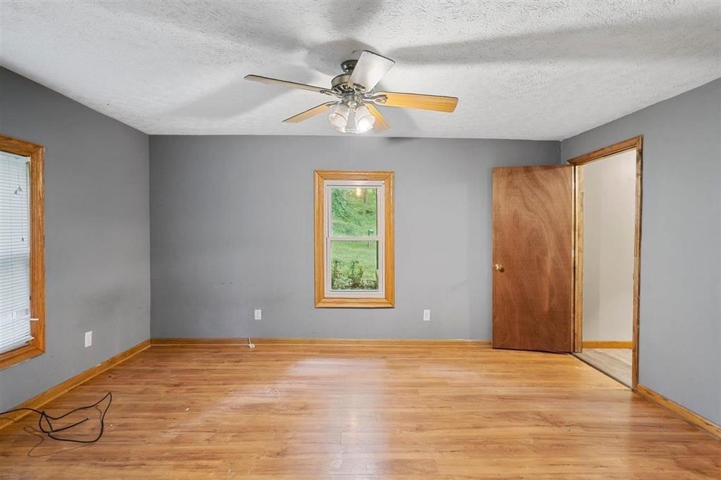 460 New Roe Road Franklin, KY 42134 - Photo 8 of 34 a view of an empty room with window and wooden floor
