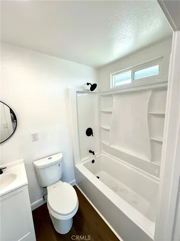 a bathroom with a toilet and a bathtub