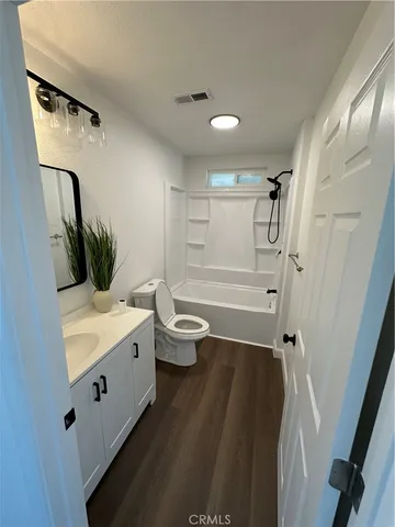 a bathroom with a double vanity sink toilet and shower