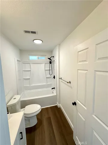 a bathroom with a toilet a sink and bathtub
