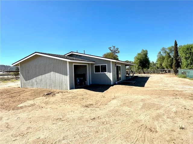 a view of house with yard and covered with snow