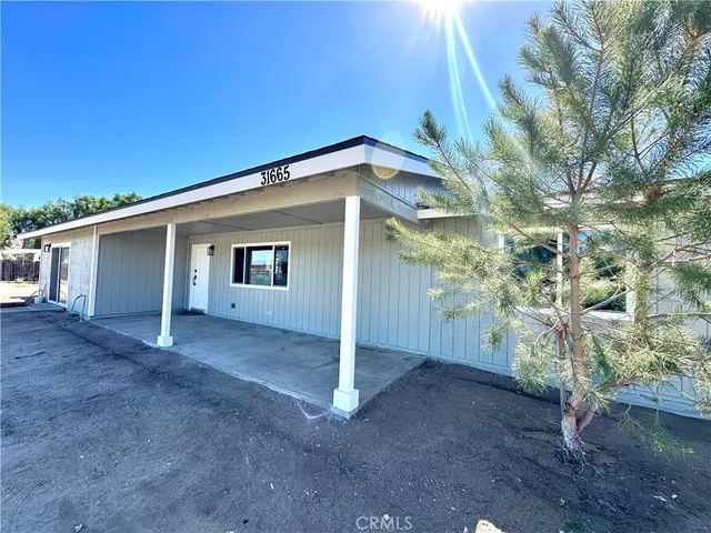 a view of a house with a tree
