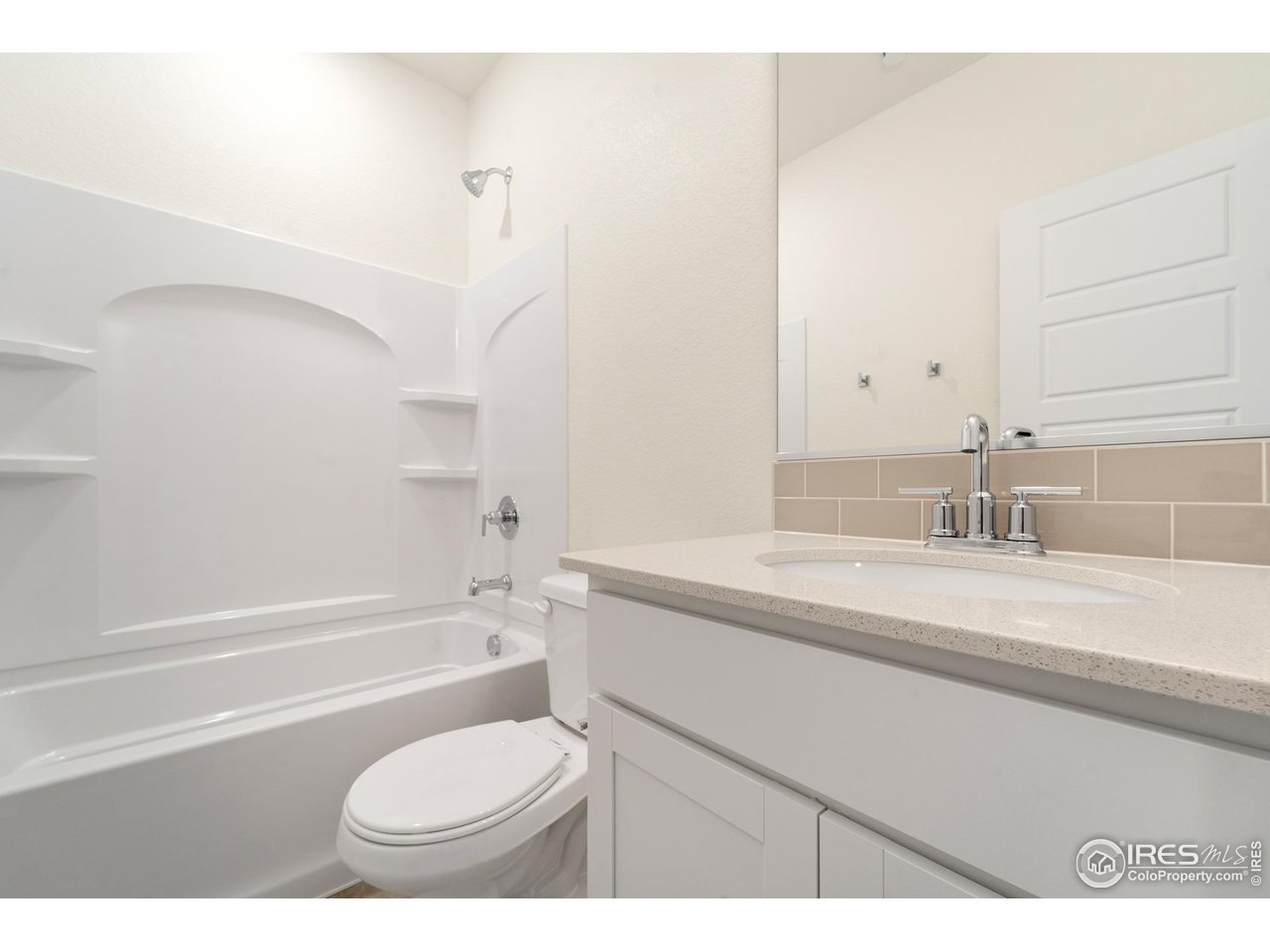 3829 Rhoadarmer Way Evans, CO 80620 - Photo 8 of 14 a bathroom with a granite countertop sink toilet a mirror and bathtub