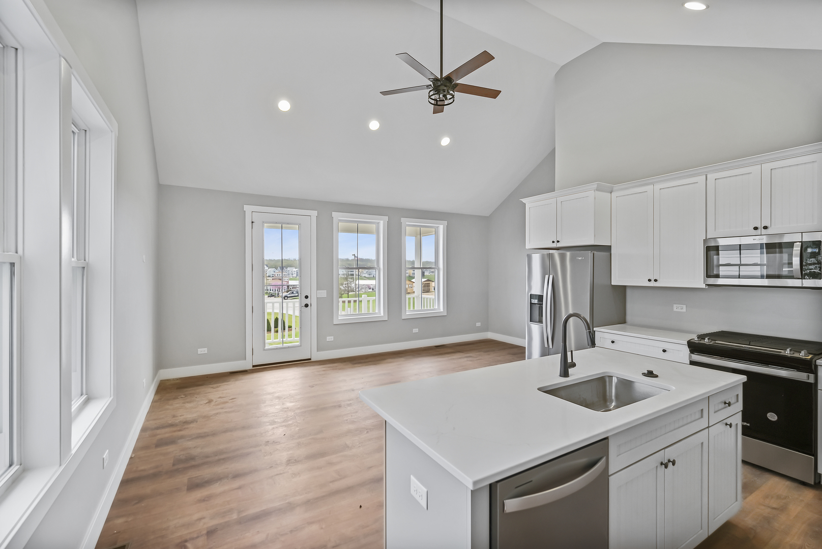 100 Great Loop E Drive, Unit 38 Ottawa, IL 61350 - Photo 8 of 15 a kitchen with stainless steel appliances granite countertop a sink a stove a refrigerator and island with wooden floor