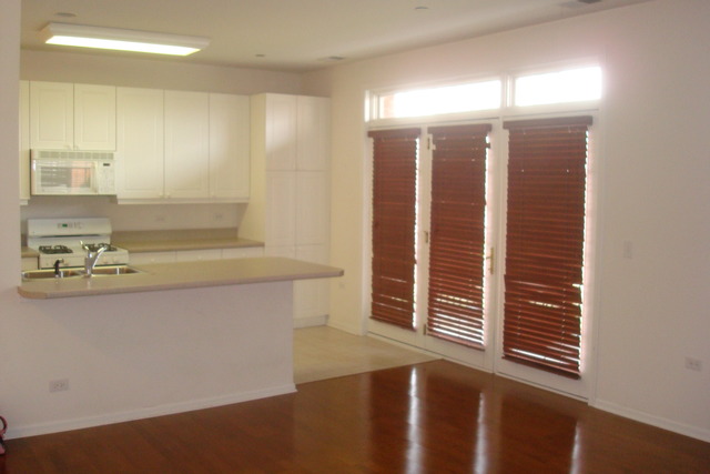 640 McHenry Road, Unit 2208 Wheeling, IL 60090 - Photo 7 of 17 a view of kitchen and hall with wooden floor