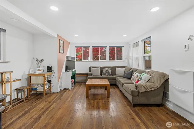 a living room with furniture and wooden floor