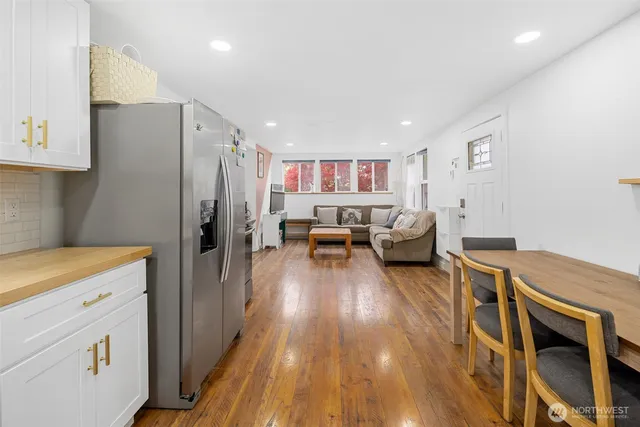 a kitchen with a refrigerator and a stove top oven