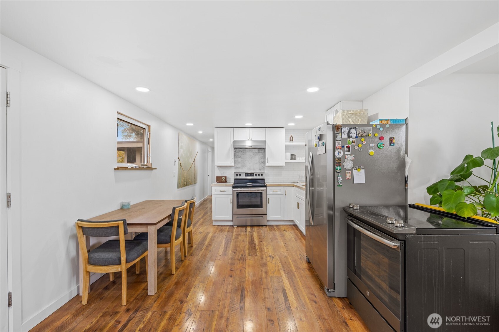 1645 South 272nd Street, Unit 13 Federal Way, WA 98003 - Photo 13 of 27 a kitchen with granite countertop a refrigerator oven a sink dishwasher and wooden floor