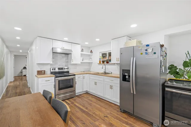 a kitchen with a refrigerator stove and sink