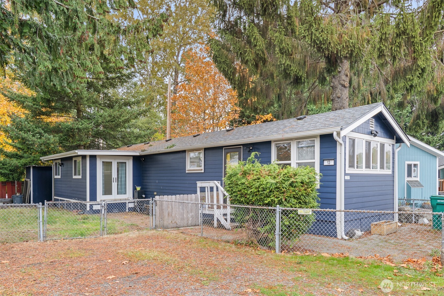 1645 South 272nd Street, Unit 13 Federal Way, WA 98003 - Photo 2 of 27 a view of a house with a yard and table and chairs under an umbrella