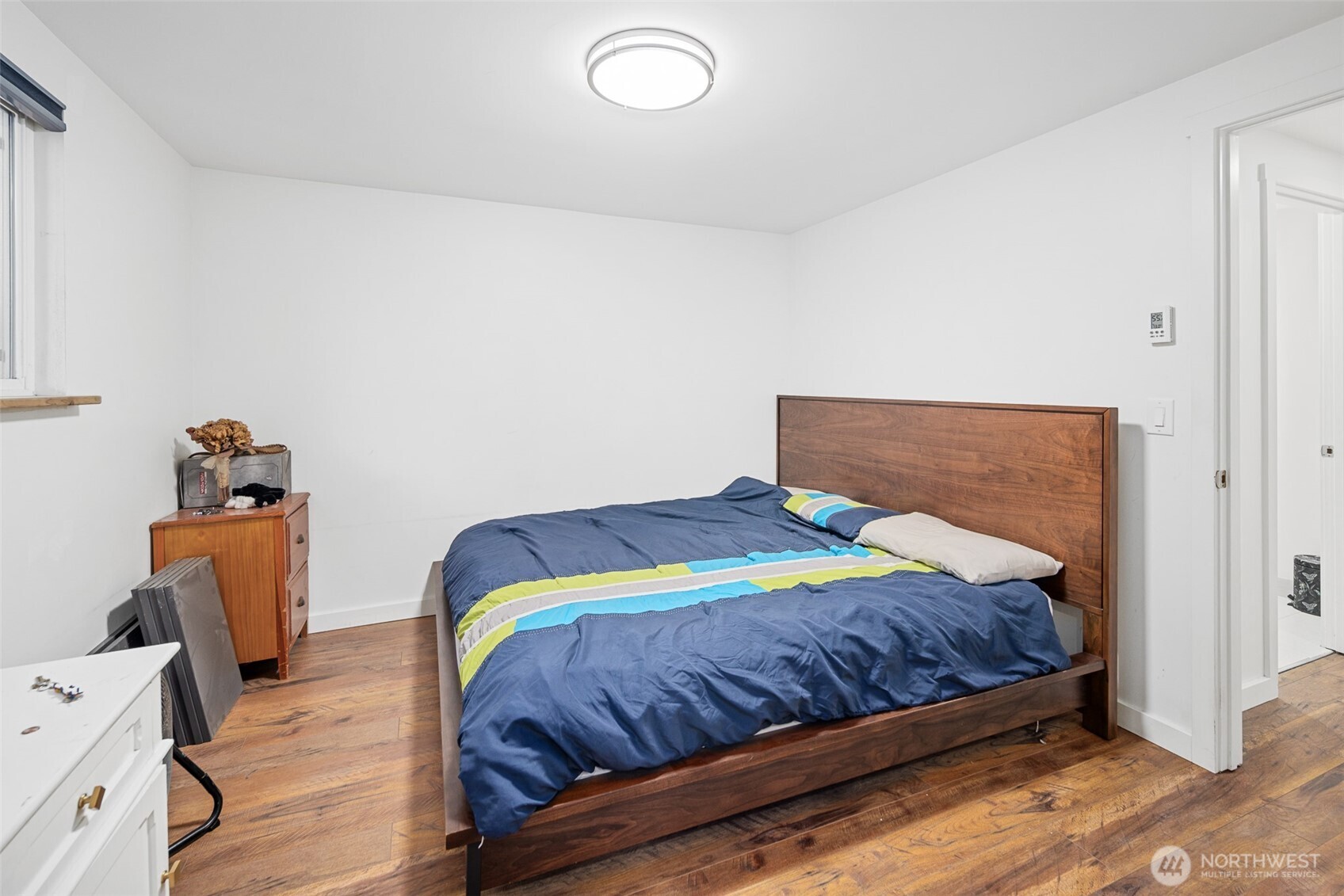 1645 South 272nd Street, Unit 13 Federal Way, WA 98003 - Photo 23 of 27 a bedroom with a bed and wooden floor