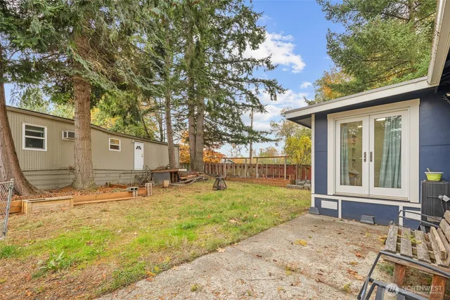 a backyard of a house with barbeque oven table and chairs