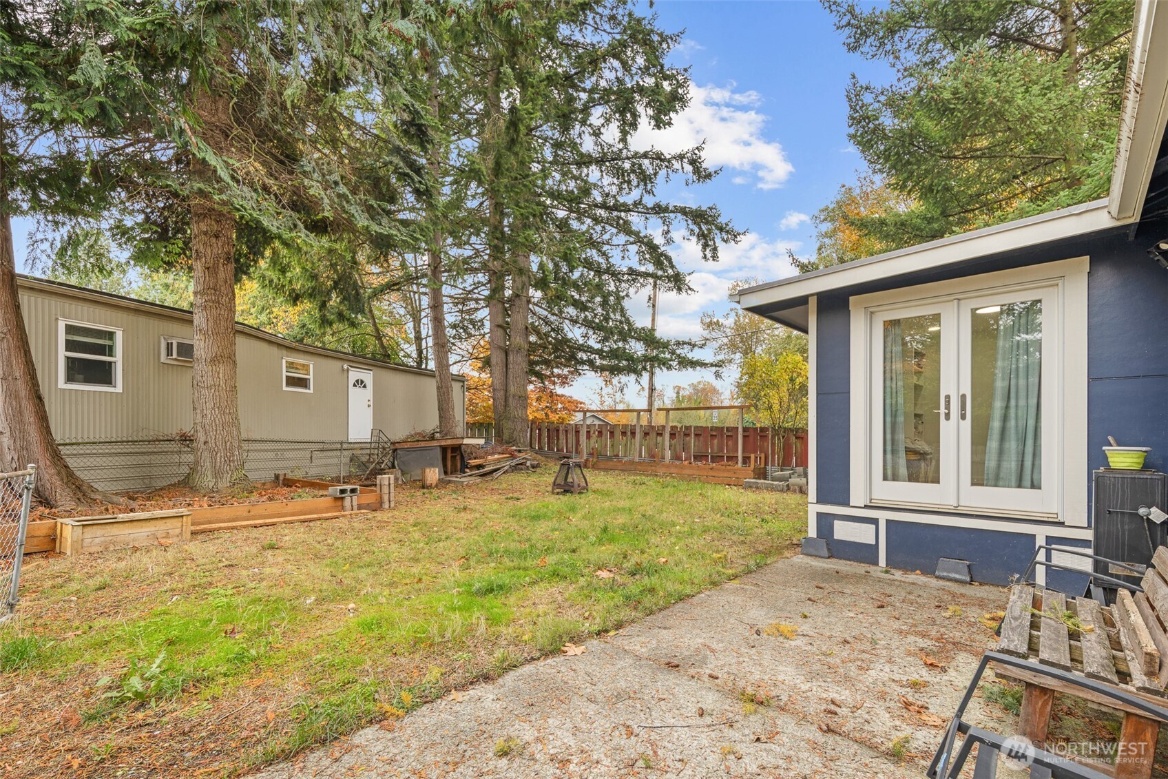 1645 South 272nd Street, Unit 13 Federal Way, WA 98003 - Photo 4 of 27 a backyard of a house with barbeque oven table and chairs