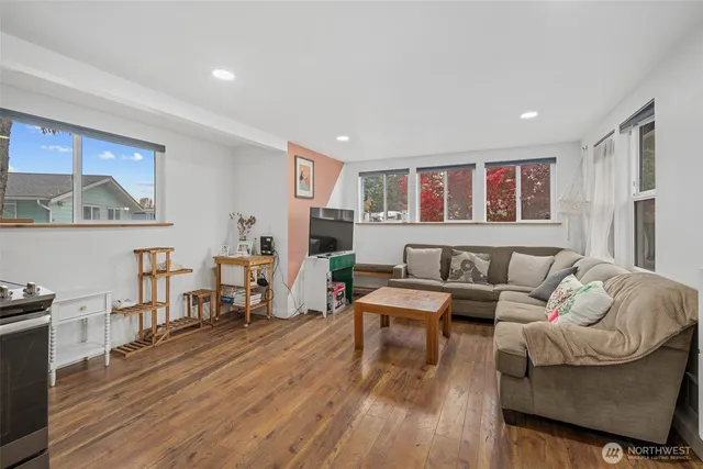 a living room with furniture and wooden floor
