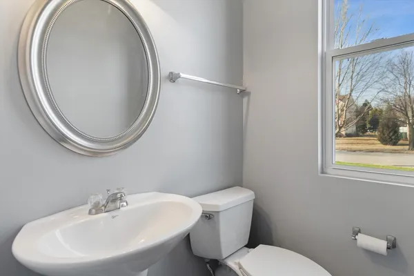a bathroom with a sink mirror and toilet