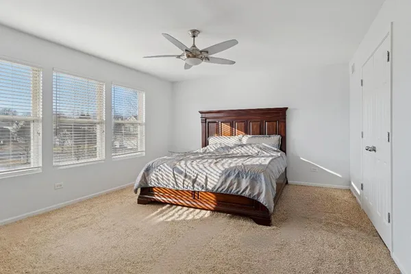 a spacious bedroom with a bed and window