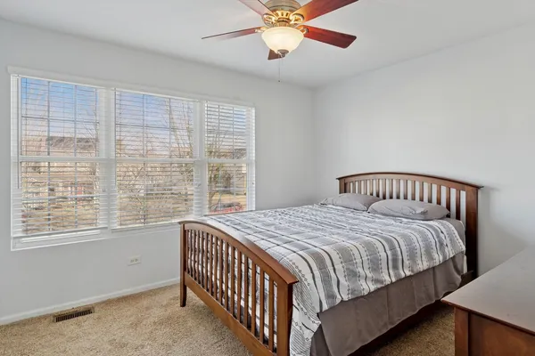 a bedroom with a large bed and a window