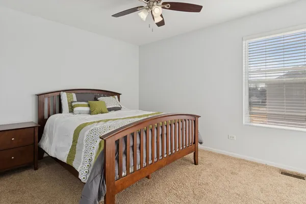 a bedroom with a bed and window