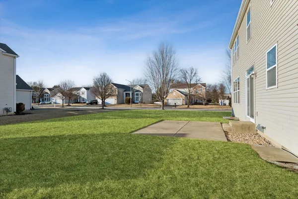 a view of yard with swimming pool and green space